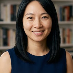 Professional AI LinkedIn headshot in Navy blue sleeveless dress on Bookshelf (thought-leader)
