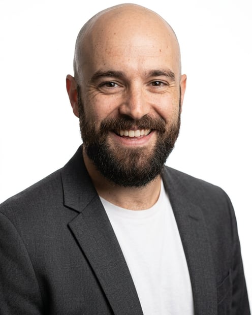 White / Pure White Studio · Charcoal gray open blazer over white tee headshot example