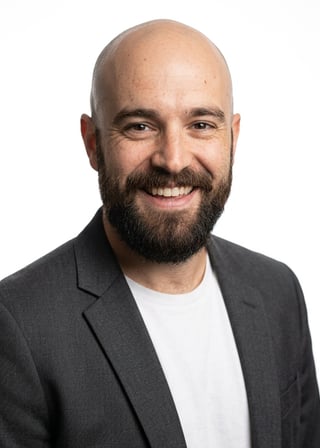 Professional AI LinkedIn headshot in Charcoal gray open blazer over white tee on White / Pure White Studio