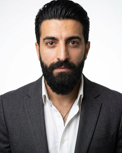 White / Pure White Studio · Charcoal gray blazer headshot example