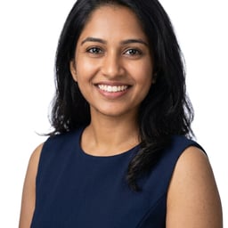 Professional AI LinkedIn headshot in Navy blue sleeveless dress on White / Pure White Studio