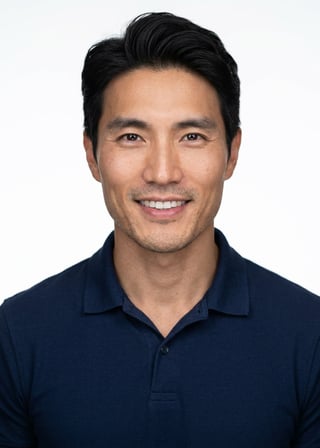 Professional AI LinkedIn headshot in Navy blue short-sleeve polo on White / Pure White Studio