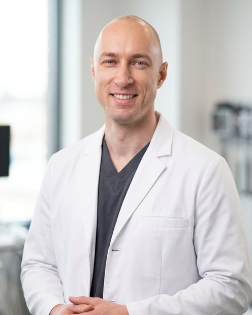 Soft Blue Clinic Interior · White Coat over Scrubs headshot example