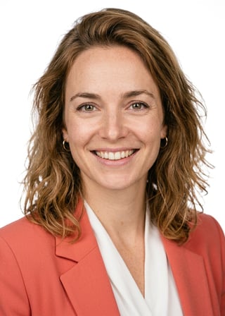 Professional AI LinkedIn headshot in Coral blazer over white blouse on White / Pure White Studio