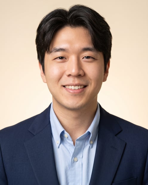 Warm Studio · Navy Blazer headshot example