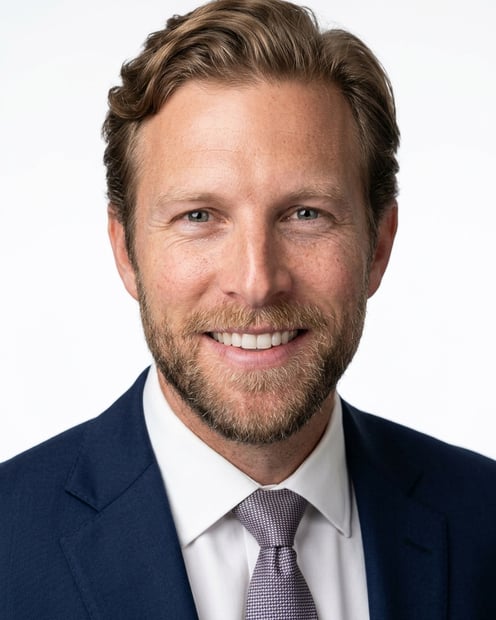White / Pure White Studio · Navy tailored suit headshot example