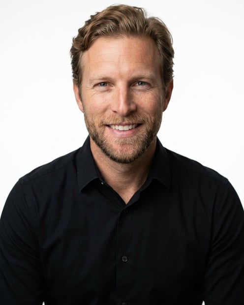 White / Pure White Studio · Black long-sleeve button-up headshot example