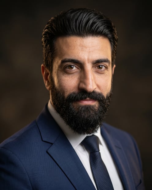 Dark / Dramatic Dark · Navy tailored suit headshot example