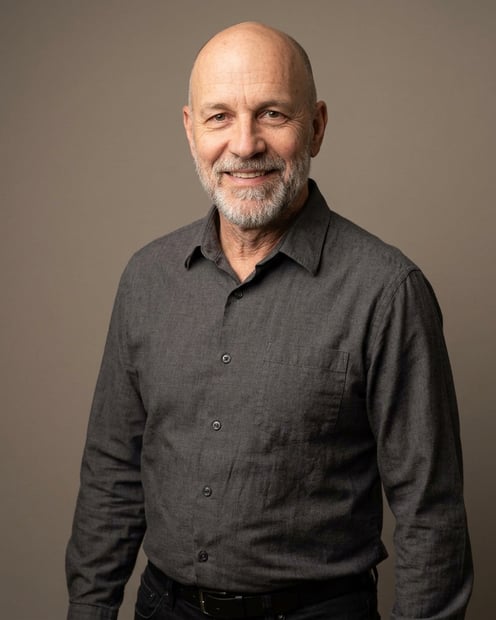 Warm Grey Studio Sweep · Charcoal Button-Up with Dark Pants headshot example