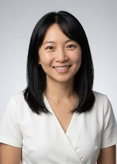 Professional AI LinkedIn headshot in White wrap dress on Neutral Gradient / Light Grey