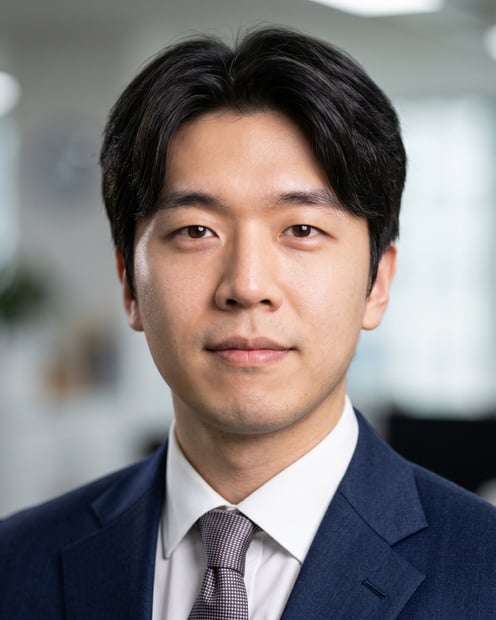 Office / Modern Office Workspace · Dark blue tailored suit headshot example
