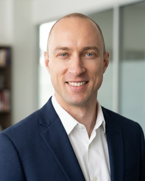 Office / Modern Office Workspace · Navy tailored suit headshot example
