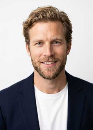 Professional AI LinkedIn headshot in Open navy blazer over simple white tee (tech-casual) on White / Pure White Studio