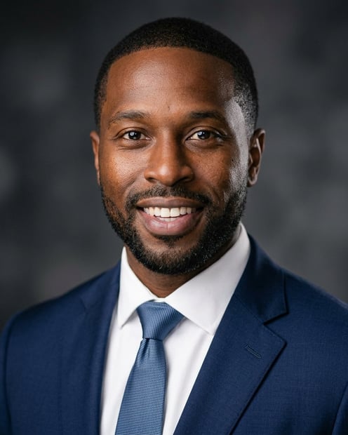 Dark / Dramatic Dark · Navy tailored suit headshot example