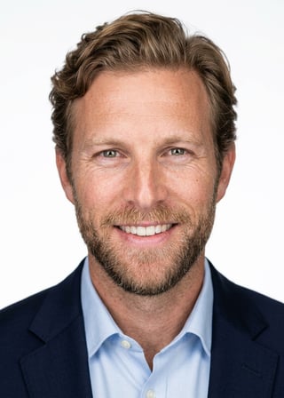 Professional AI LinkedIn headshot in Navy blazer with light blue shirt on White / Pure White Studio