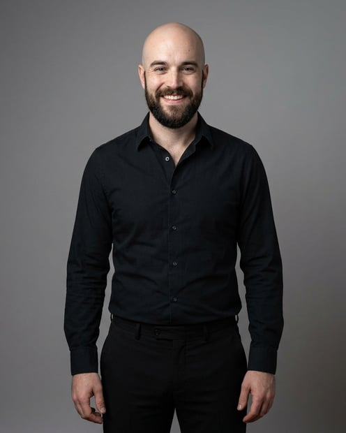 Neutral Mid-Grey Gradient Seamless · Black Button-Up with Dark Trousers headshot example