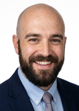 Professional AI LinkedIn headshot in Navy blazer with light blue shirt on White / Pure White Studio