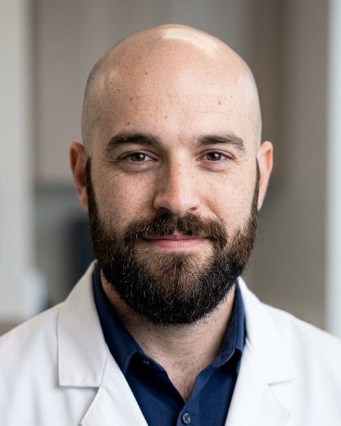 Warm Consultation Room · Physician White Coat headshot example