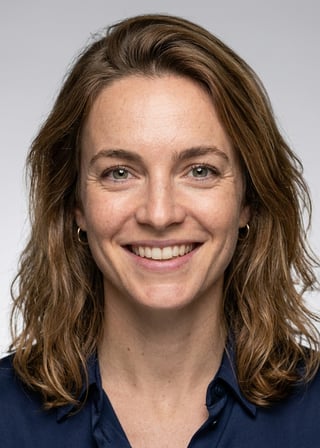 Professional AI LinkedIn headshot in Silk blouse trousers on Neutral Gradient / Light Grey