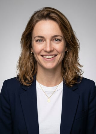Professional AI LinkedIn headshot in Open navy blazer over simple white tee (tech-casual) on Neutral Gradient / Light Grey