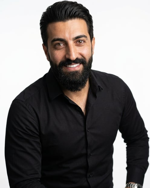 White / Pure White Studio · Black long-sleeve button-up headshot example