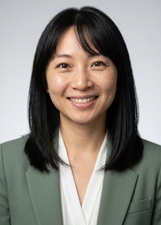 Professional AI LinkedIn headshot in Sage green blazer with white blouse (2026 trend) on Neutral Gradient / Light Grey