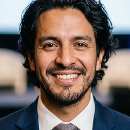 Professional AI LinkedIn headshot in Navy tailored suit on Public Speaking Stage