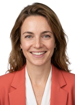 Professional AI LinkedIn headshot in Coral blazer over white blouse on White / Pure White Studio