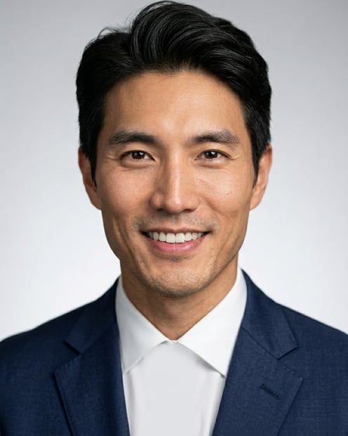 Neutral Gradient / Light Grey · Navy tailored suit headshot example