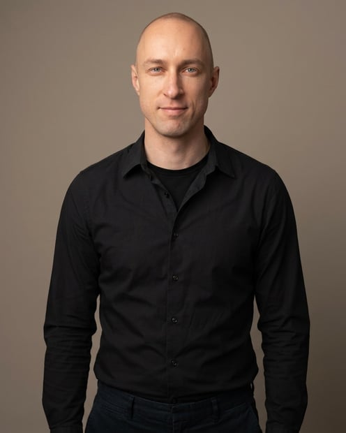 Warm Grey Studio Sweep · Black Button-Up with Dark Trousers headshot example