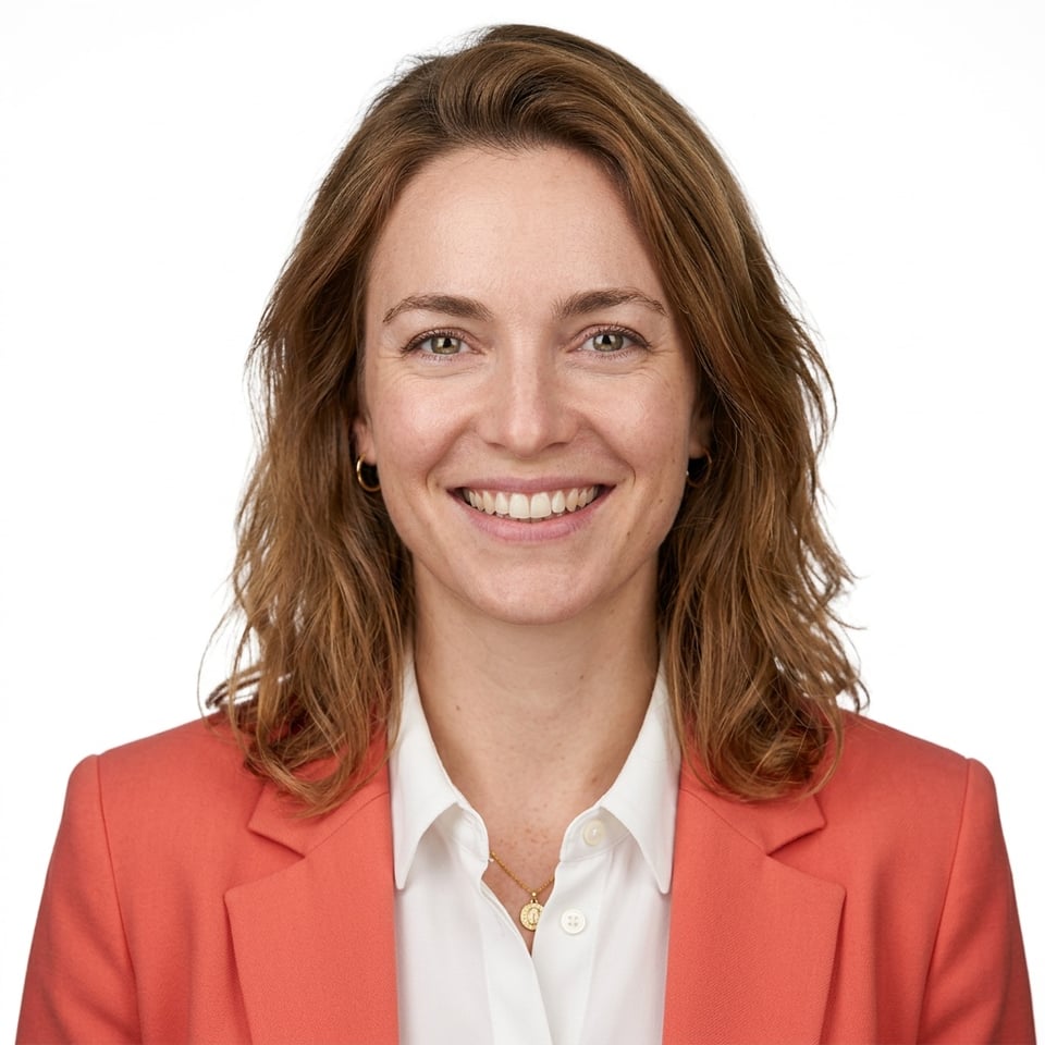 Professional AI LinkedIn headshot in Coral blazer over white blouse on White / Pure White Studio
