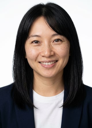 Professional AI LinkedIn headshot in Open navy blazer over simple white tee (tech-casual) on White / Pure White Studio