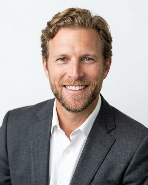 White / Pure White Studio · Charcoal gray blazer headshot example