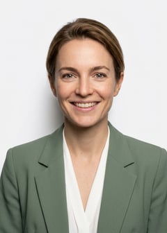 Professional AI LinkedIn headshot in Sage green blazer with white blouse (2026 trend) on White / Pure White Studio