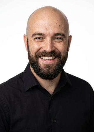 Professional AI LinkedIn headshot in Black long-sleeve button-up (variant) on White / Pure White Studio