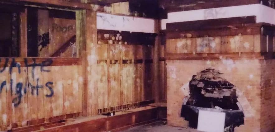 Reception room with graffitti and fire place destroyed 
