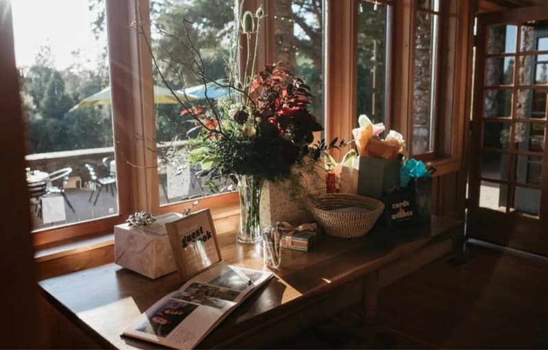 Window seat with flowers and a guest book inside the Reception Hall
