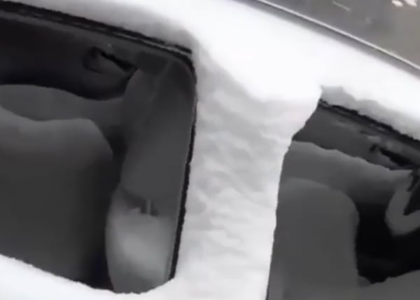 Driver's car gets snowed in