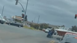 Man on scooter pulls boat