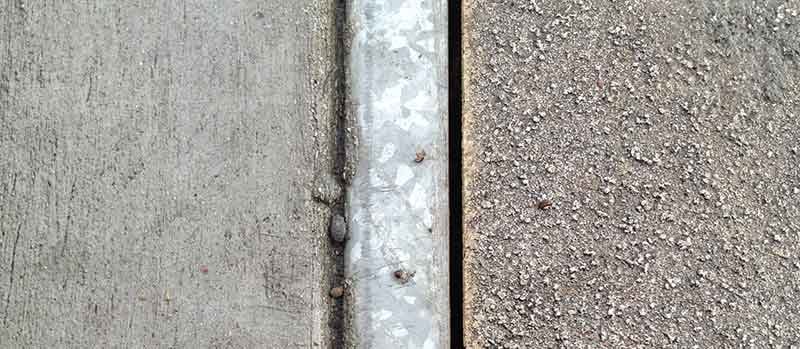 The texture and shading on a sidewalk. 