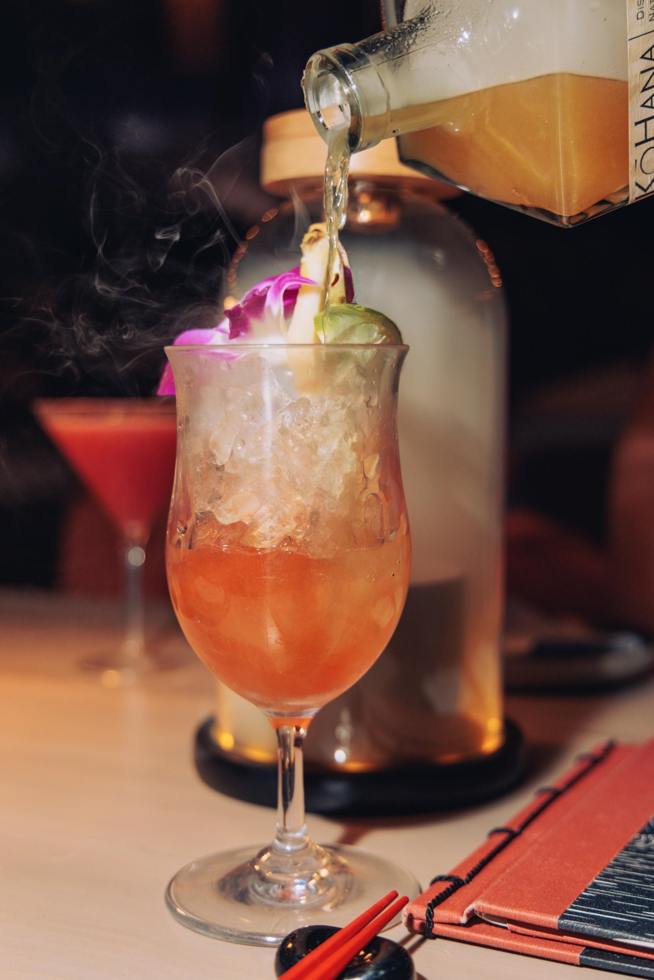 A tropical cocktail being poured over ice at the bar, Four Seasons Oʻahu
