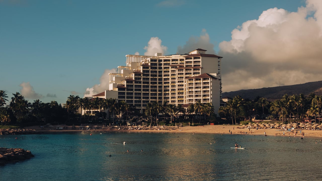 The Four Seasons Resort Oʻahu tower rising above the Ko Olina lagoon at golden hour, Hawaiʻi