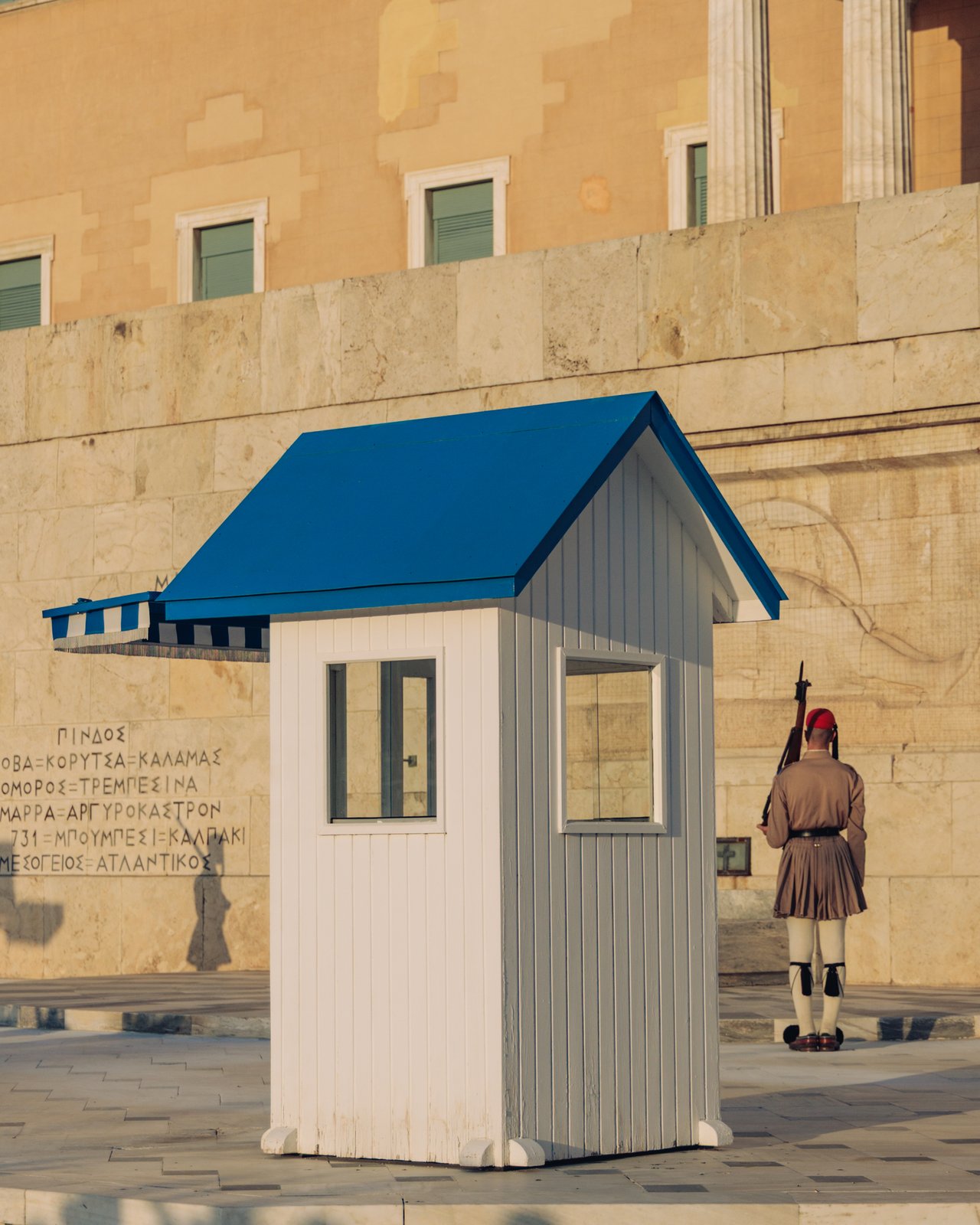 An Evzone in traditional uniform on guard by a sentry box, Athens, Greece