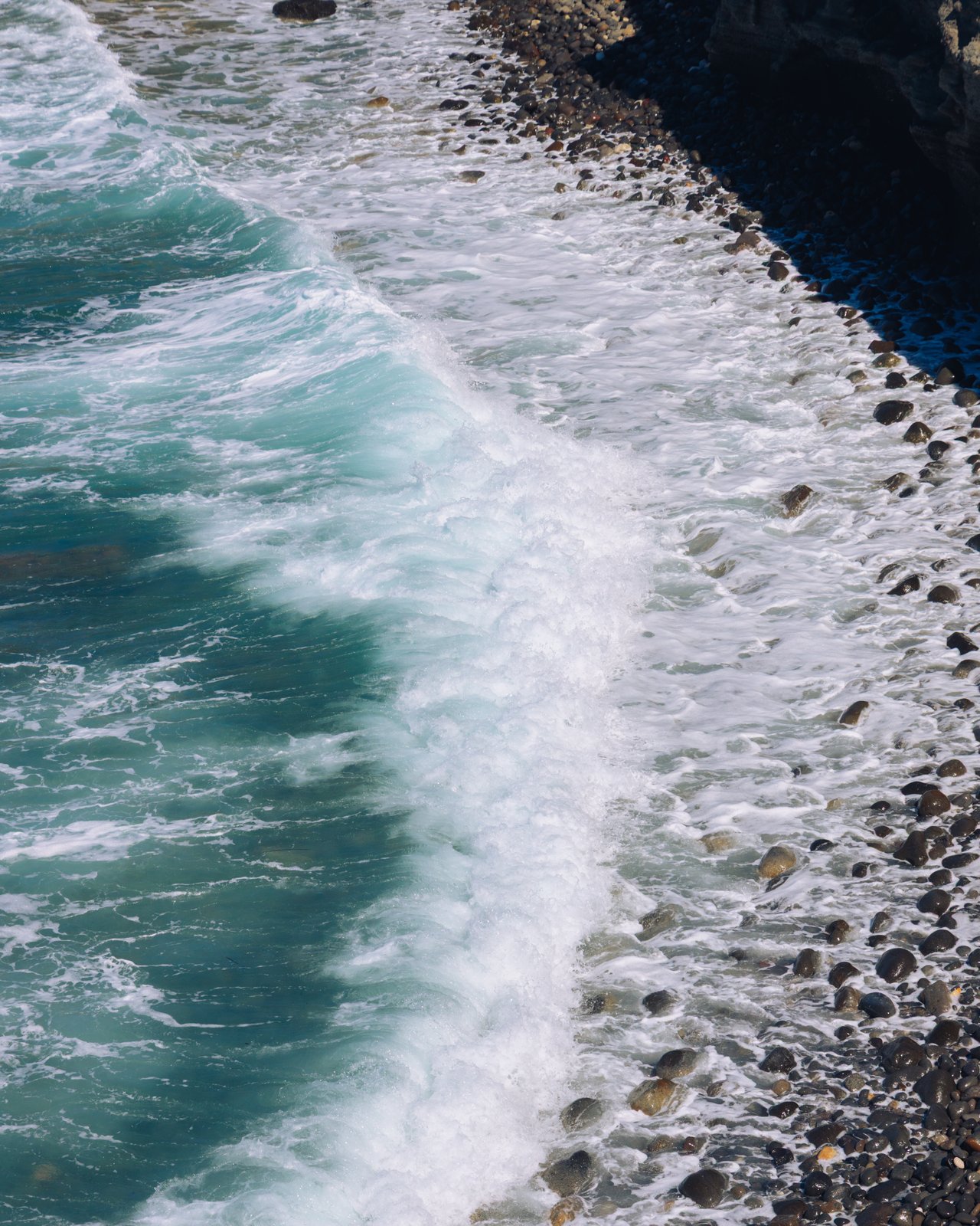 Waves rolling onto a pebble shore, Greece