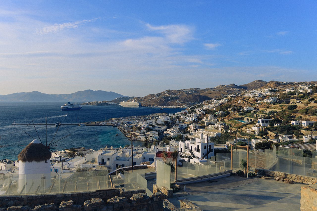 An elevated view over Mykonos town and its harbour with a cruise ship, Greece