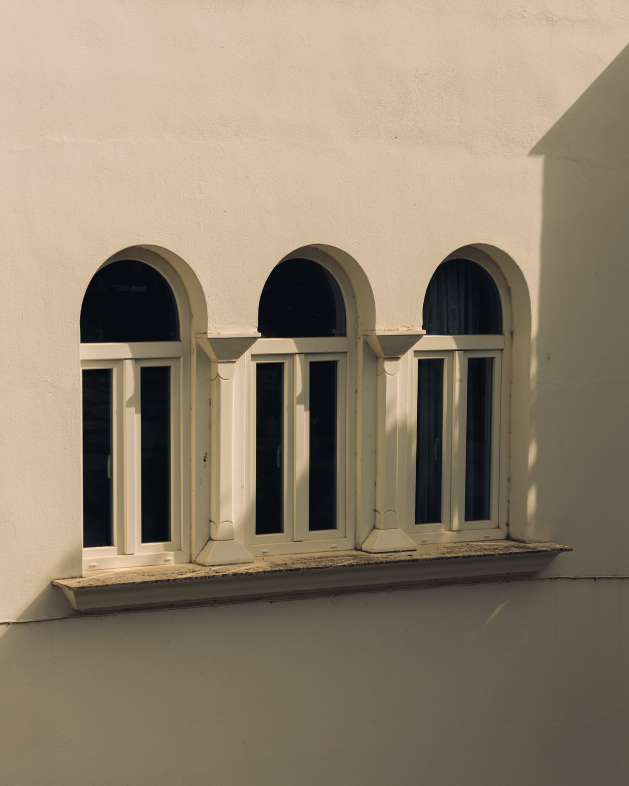 A triple-arched Cycladic window on a white wall, Greece