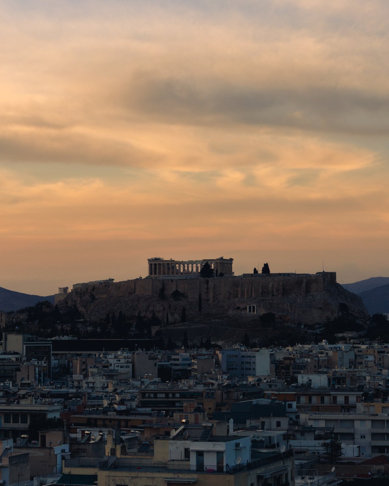 The Acropolis and Parthenon above Athens at golden hour, Greece