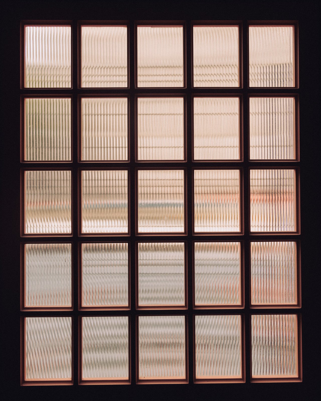 A grid of reeded glass panes glowing with daylight, Ignacia Guest House