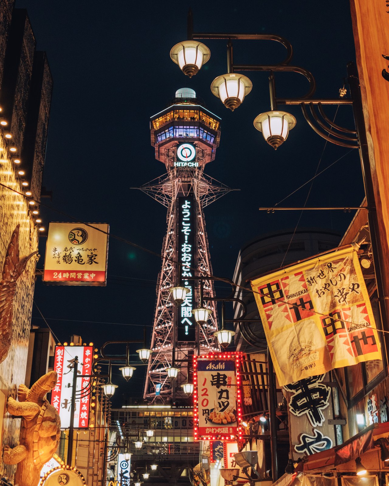 Tsutenkaku Tower lit up above the neon of Shinsekai at night, Osaka