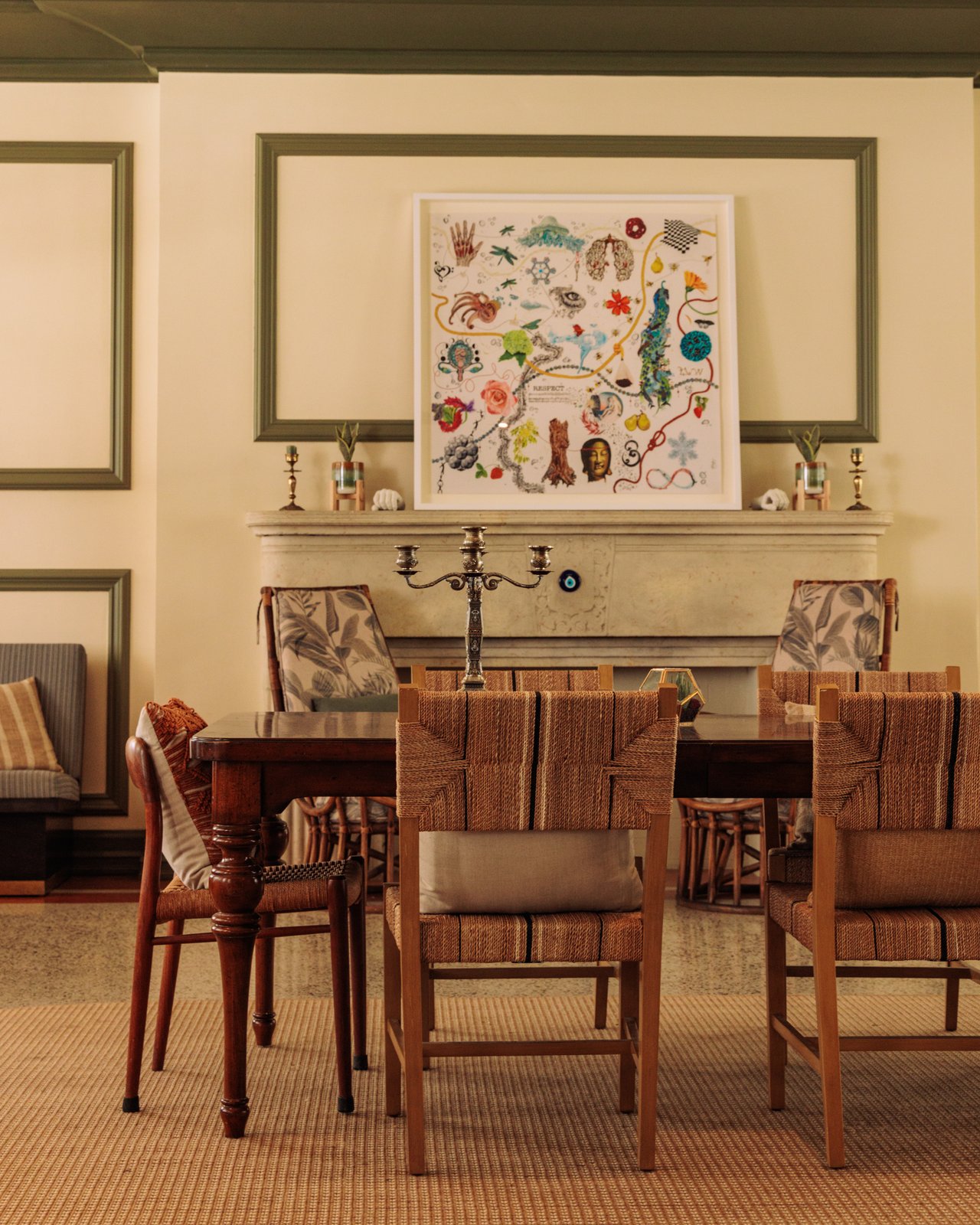 A dining room with woven-back chairs and a colourful framed artwork over the mantel, The Balfour Hotel